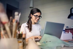 woman looking at her credit score online to find out about how much mortgage she qualifies for