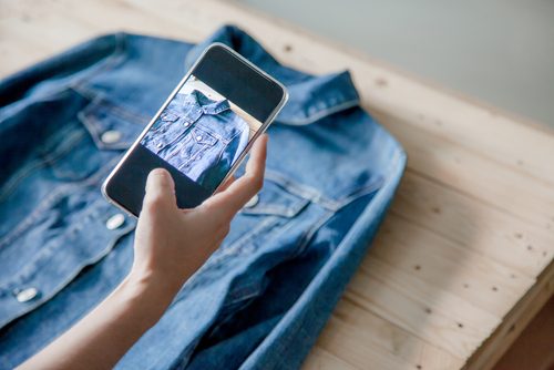 Woman selling her denim shirt online